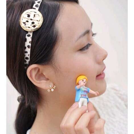 person is a girl who has a doll in her hair.