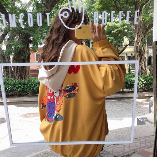 a woman is taking a picture of herself with a cell phone.