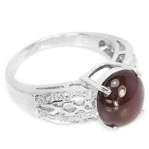 a stone ring with a red stone in the center.