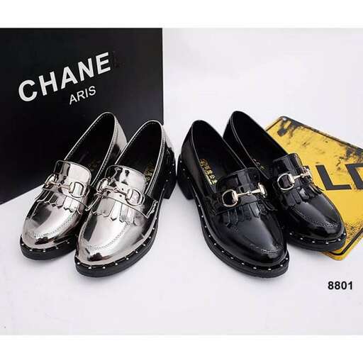 a pair of shoes with a yellow clock and a black box