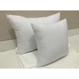 a white pillow sitting on a bed.