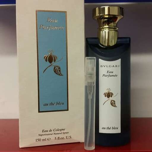 a bottle of perfume sitting on a red counter.