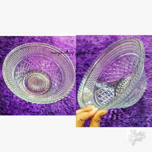a glass dish with a purple background