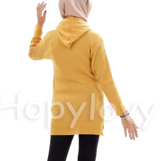 a woman in a yellow sweater