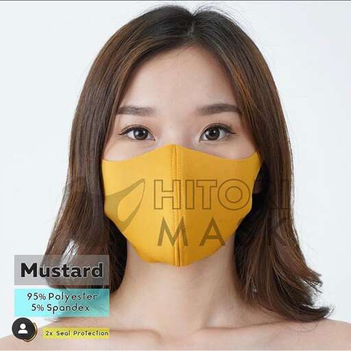 a woman with long hair wearing a yellow mask over her face