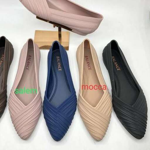 a pair of shoes with a wooden shoe holder.