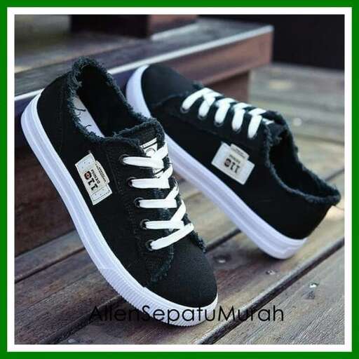 a pair of black canvas shoes with white laces.