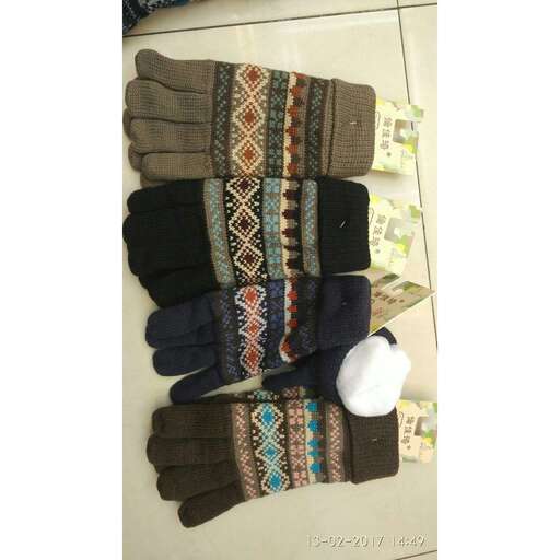 a collection of gloves and a cell phone.