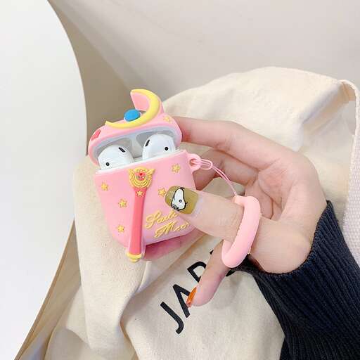 a hand holding a hello kitty keychain