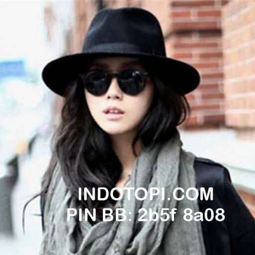 a woman wearing a hat and scarf, and a hat.