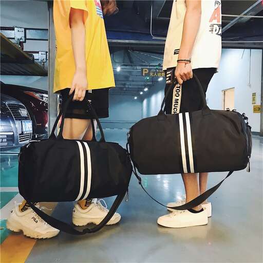 a couple of people carrying luggage in a garage.
