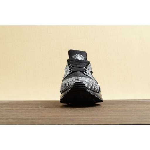 a pair of sneakers sitting on a wooden table.