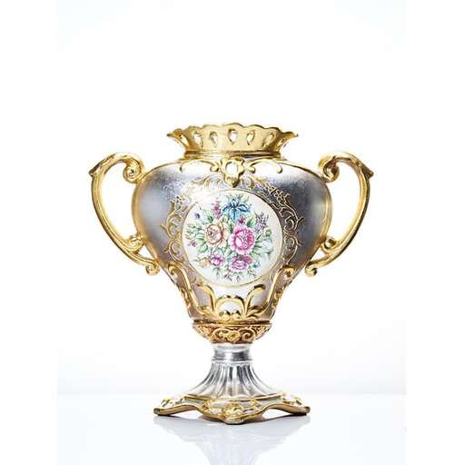 a rare silver and gold urn with a floral pattern.