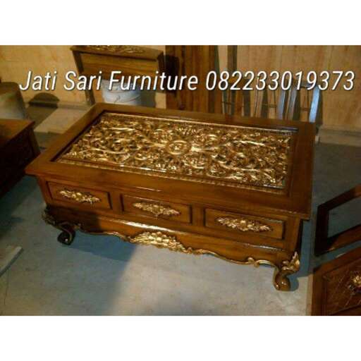 a small wooden chest with gold details on it.
