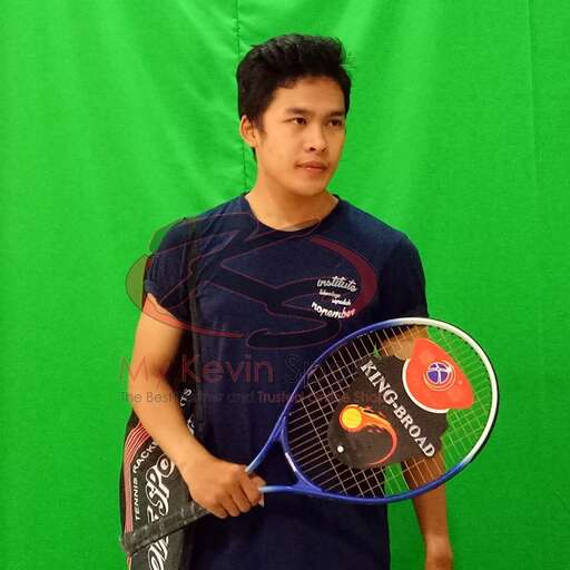 a man holding a tennis racket in front of a green screen.
