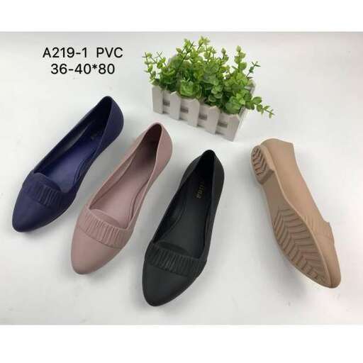 a pair of flat shoes with a planter in the background.