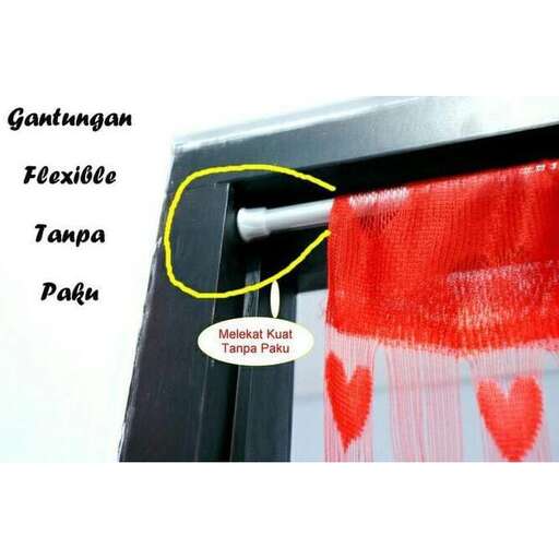 a red and white heart is placed in a window.