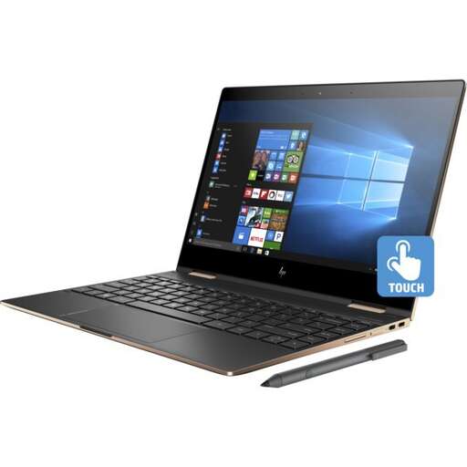 a laptop computer with a pen on top of it.
