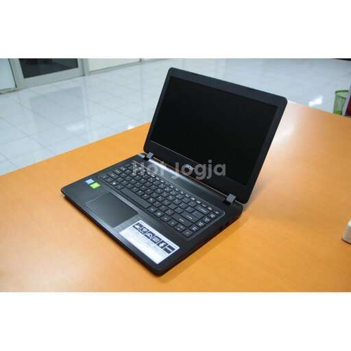 a laptop computer sitting on a table with a mouse.