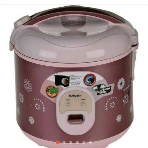 a pink crock pot with a lid on it.