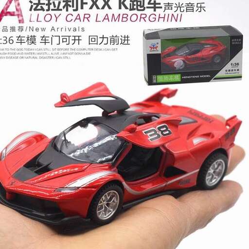 a hand holding a toy car.