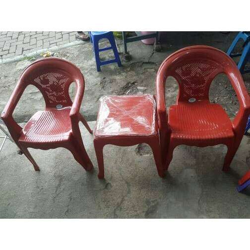a pair of red plastic chairs with plastic seats.