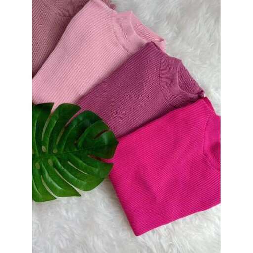 a closeup of the pink shirt and the green leaf