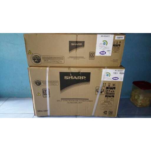 a large cardboard box sitting on top of a wooden floor.