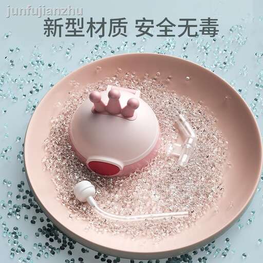 a pink teapot on a plate with a spoon in it.
