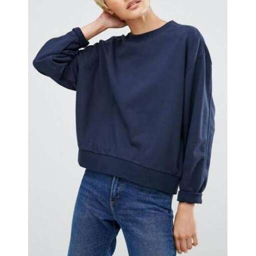 a model wears a navy blue long sleeve top with a high neckline and a high neckline.