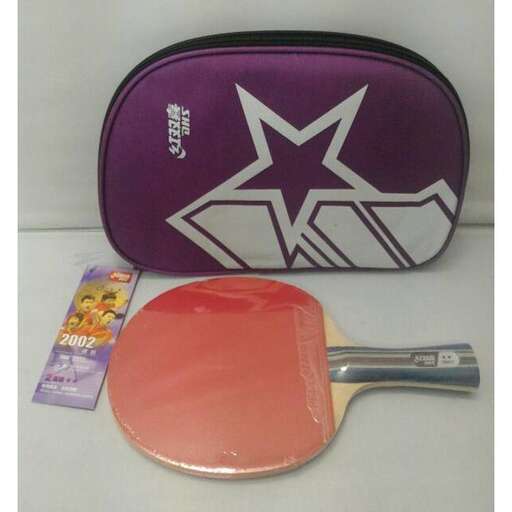 a purple and black bag sitting on top of a table.