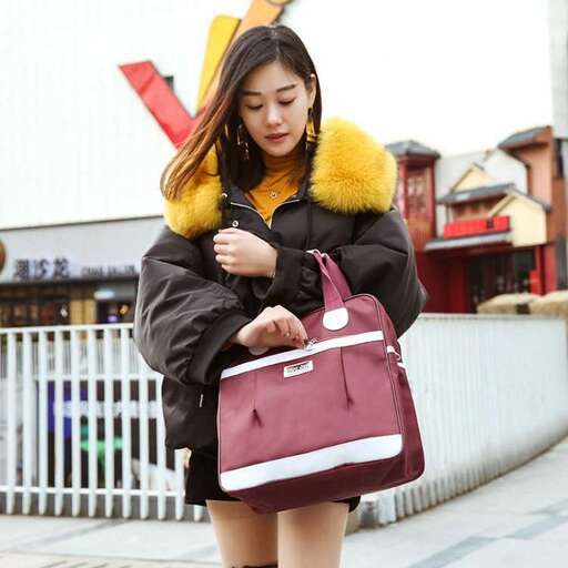 a woman in a coat and a bag