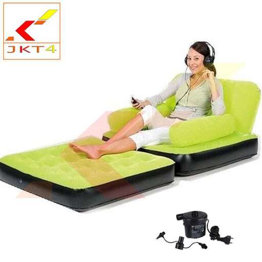 a woman sitting on a couch with headphones on.