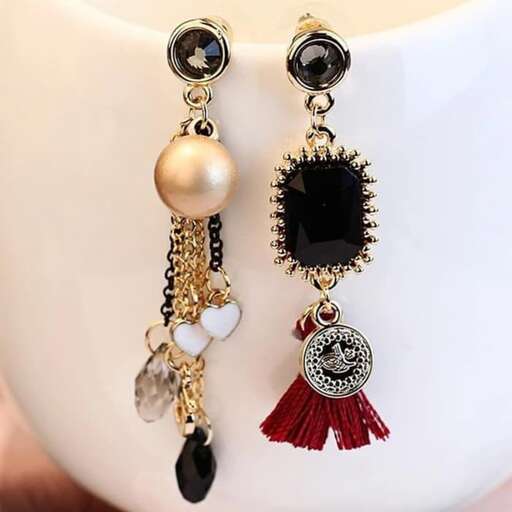a pair of earrings with a red ribbon and a black diamond.
