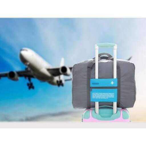 a blue and white bag sitting on top of a luggage bag.