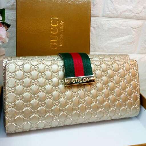 a purse with a green and red ribbon on it.