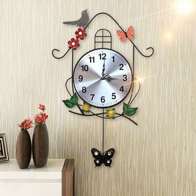 a clock hanging on a wall with flowers and a butterfly.