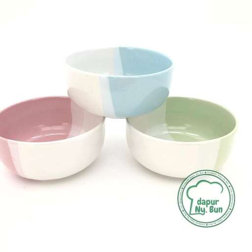 a set of bowls in pink and aqua.
