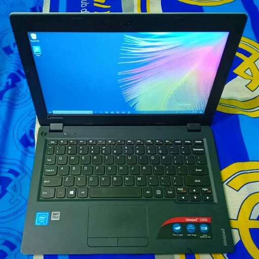 a laptop computer sitting on top of a bed.