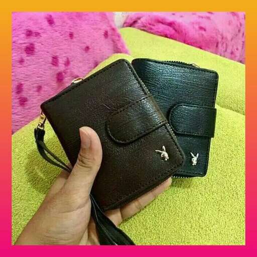 a hand holding a wallet with a yellow and pink background.