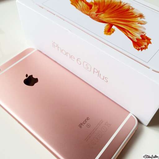 a pink iphone box with a gold flower on the back.