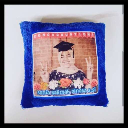 a pillow with a picture of a graduate on it.