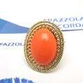 orange coral ring with a blue sky in the background