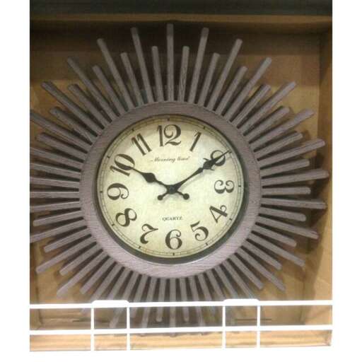 a clock with roman numerals on it is on a wall.