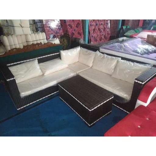 a large couch with a black cushion and a red and white bed.