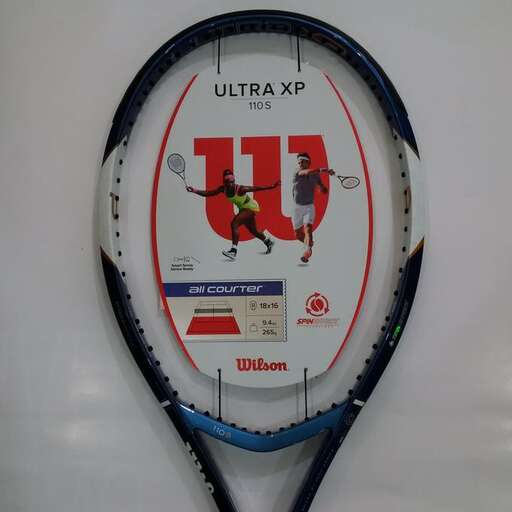 a tennis racket is hanging on a wall.