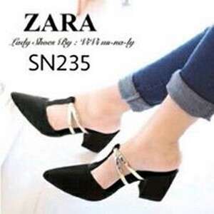 a pair of black shoes with white straps.