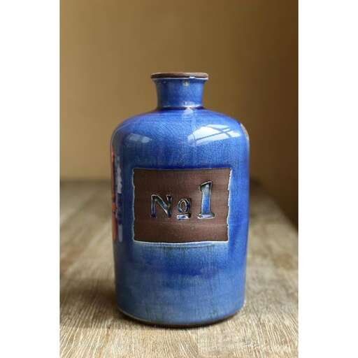 a blue vase with the letter n on it