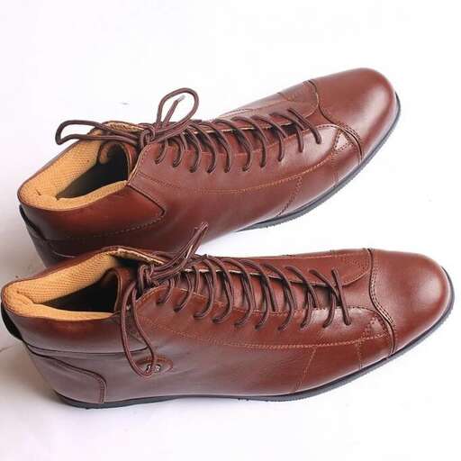 a pair of brown leather shoes with a white background.