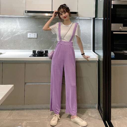 a model in a white top and a pair of white shoes.